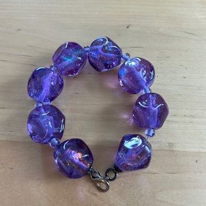 Large 1 inch iridescent, purple glass bead bracelet.